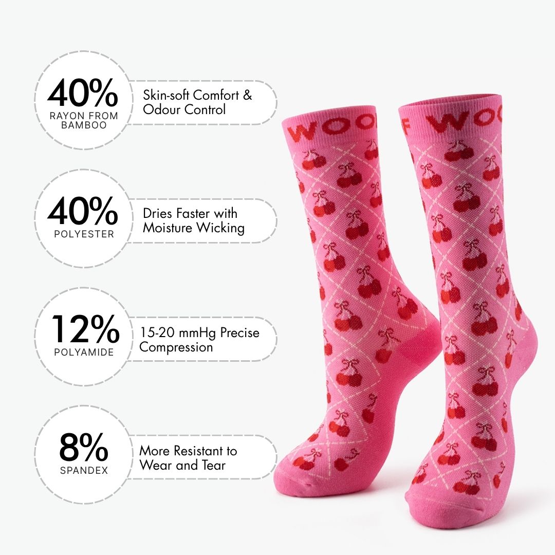 A bright pink Cherry Bows Bamboo Crew Compression Socks surrounded by key feature callout icons, including boosts circulation & reduces swelling, clinically tested compression, hypoallergenic & odor free, designed by family of doctors, and moisture-wicking properties.  